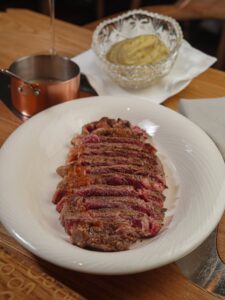 A mouthwatering dish featuring a perfectly seared steak with mashed potatoes and sauce.